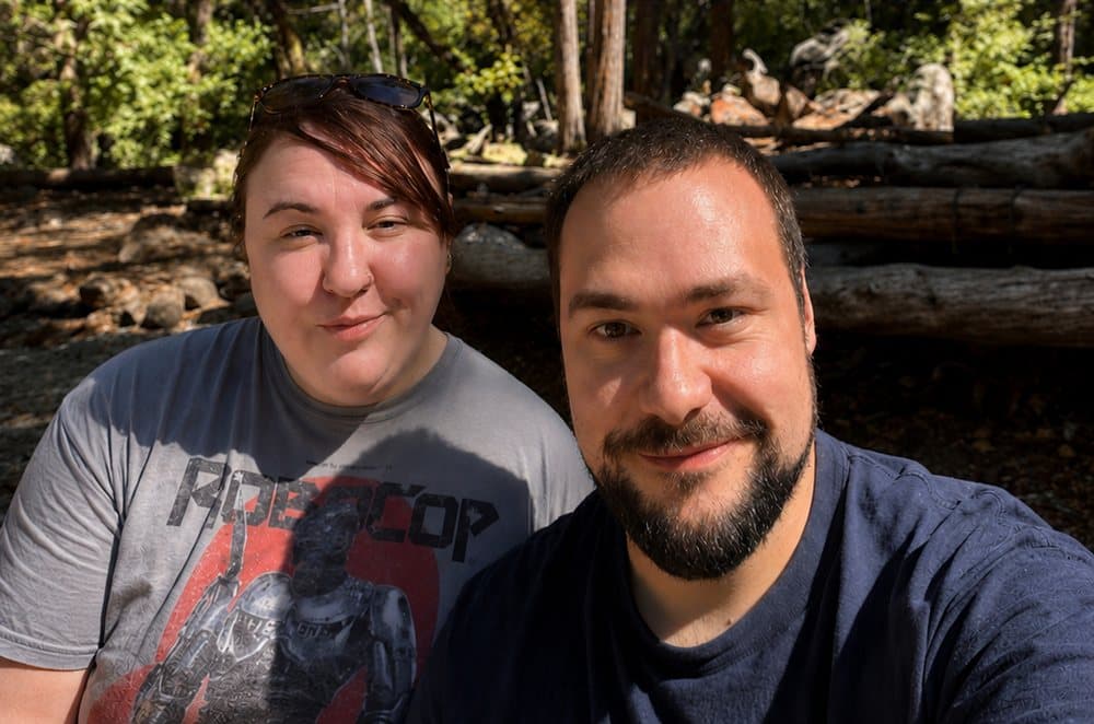 Robbie and Caitlin in front of fallen logs in the Yosemite forest